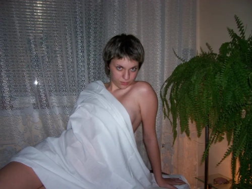 Young girl poses showing her tits and ass - explicit nude photo shoot