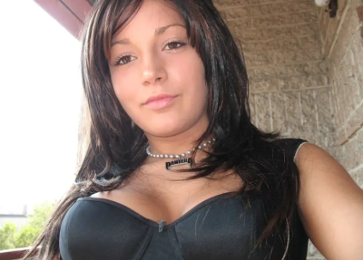 Cute girl with beautiful breasts shows her shaved pussy
