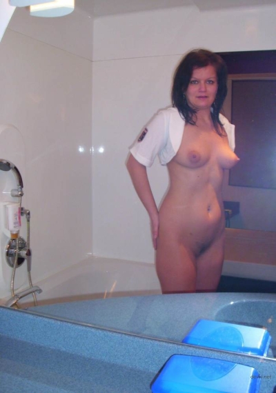A mature mother poses in the bathroom showing off her charms