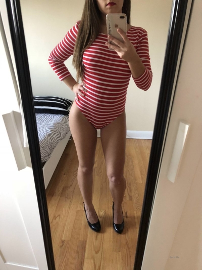 Beautiful breasts of a girl in a striped bodysuit