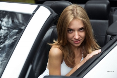 Beautiful girl posing naked in the car