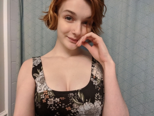 Seductive redhead babe takes sultry selfie in dimly lit room mirror