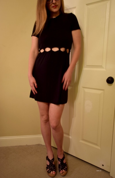 posing in a short black dress