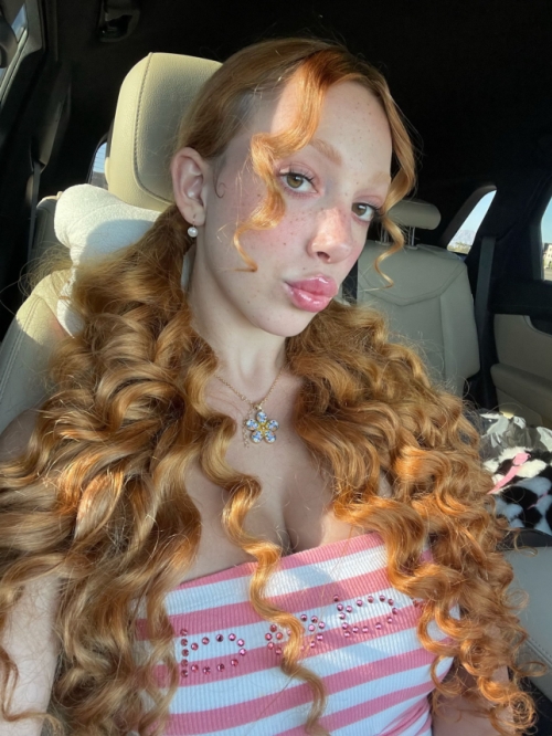 Redhead girl flaunts her attractive big boobs