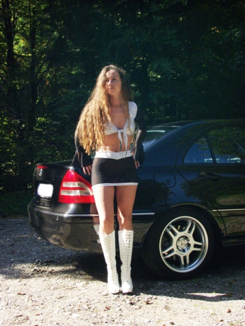 Mature Woman Posing in Car, Showing Off Curves in Provocative Display