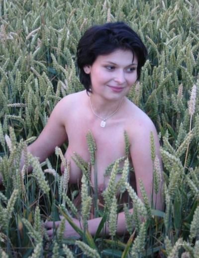 Posing naked in a field