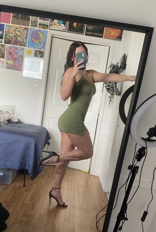 Hot girl flaunts body, takes sexy selfie on smartphone camera.