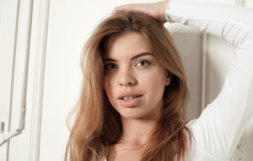 Naked model showcasing her explicit body in provocative photo shoot