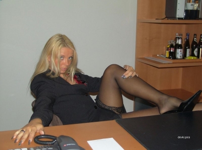 Mature secretary posing in the office