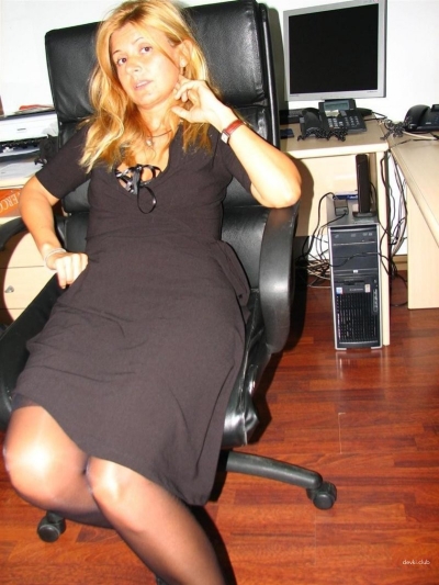 An adult lady in stockings spreads her legs