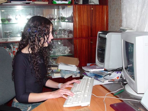 Girl relaxes in front of computer and unintentionally exposes herself