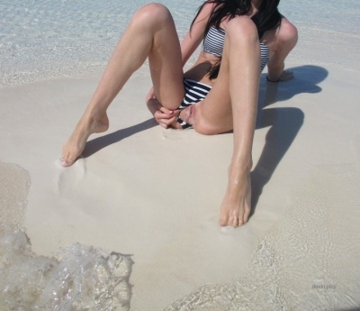 Brunette flashes pussy on the beach