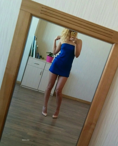 Blonde girl in a dress without panties