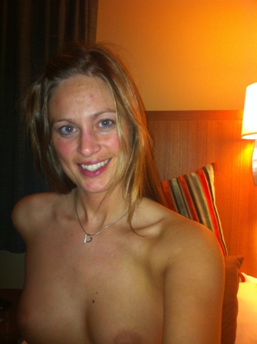 Sensual girl posing nude in hotel room during vacation
