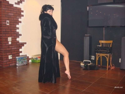 Sexy naked woman in a fur coat