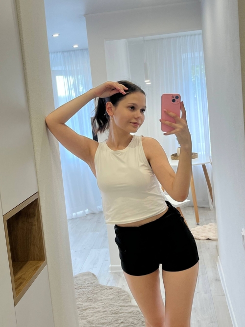 Young woman with large areolas frequently poses nude in various outfits