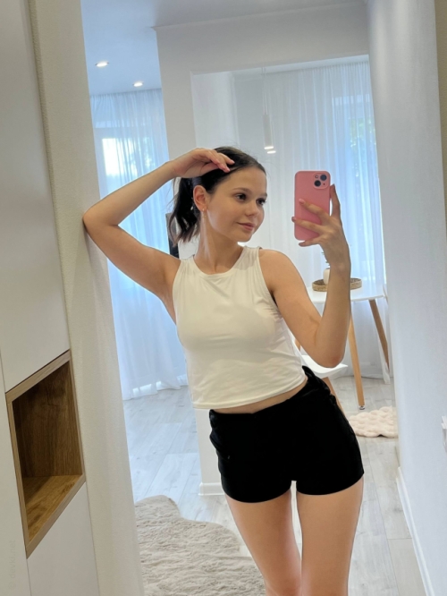 Young woman with large areolas frequently poses nude in various outfits